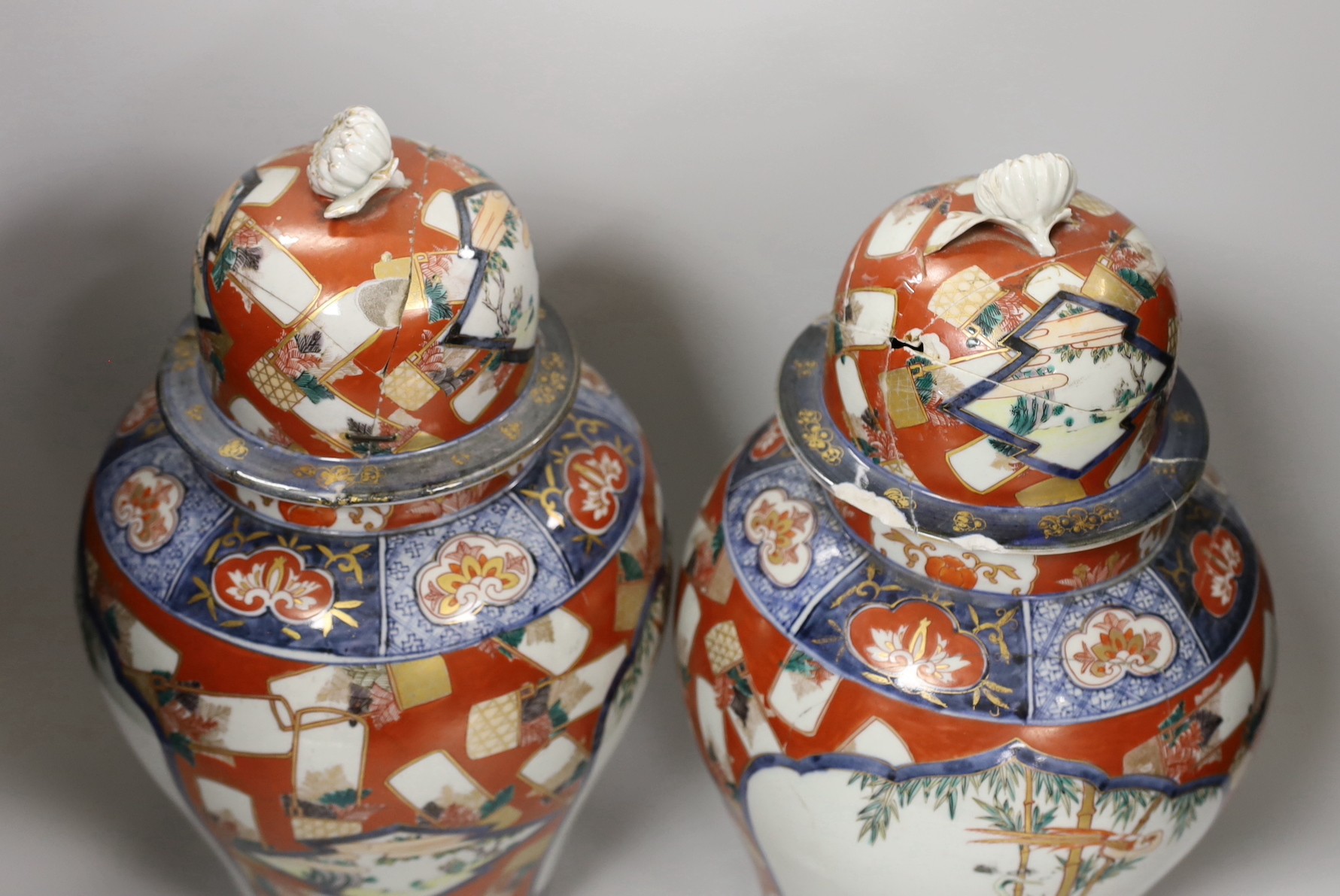 A pair of Imari vases and covers. 39cm high